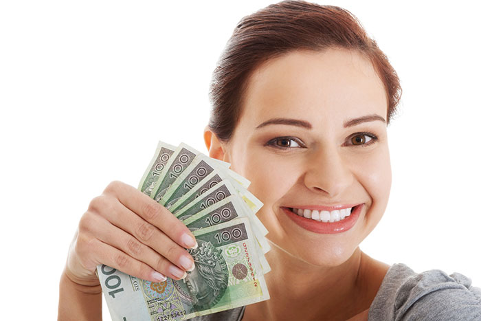 Beautiful casual woman holding money.