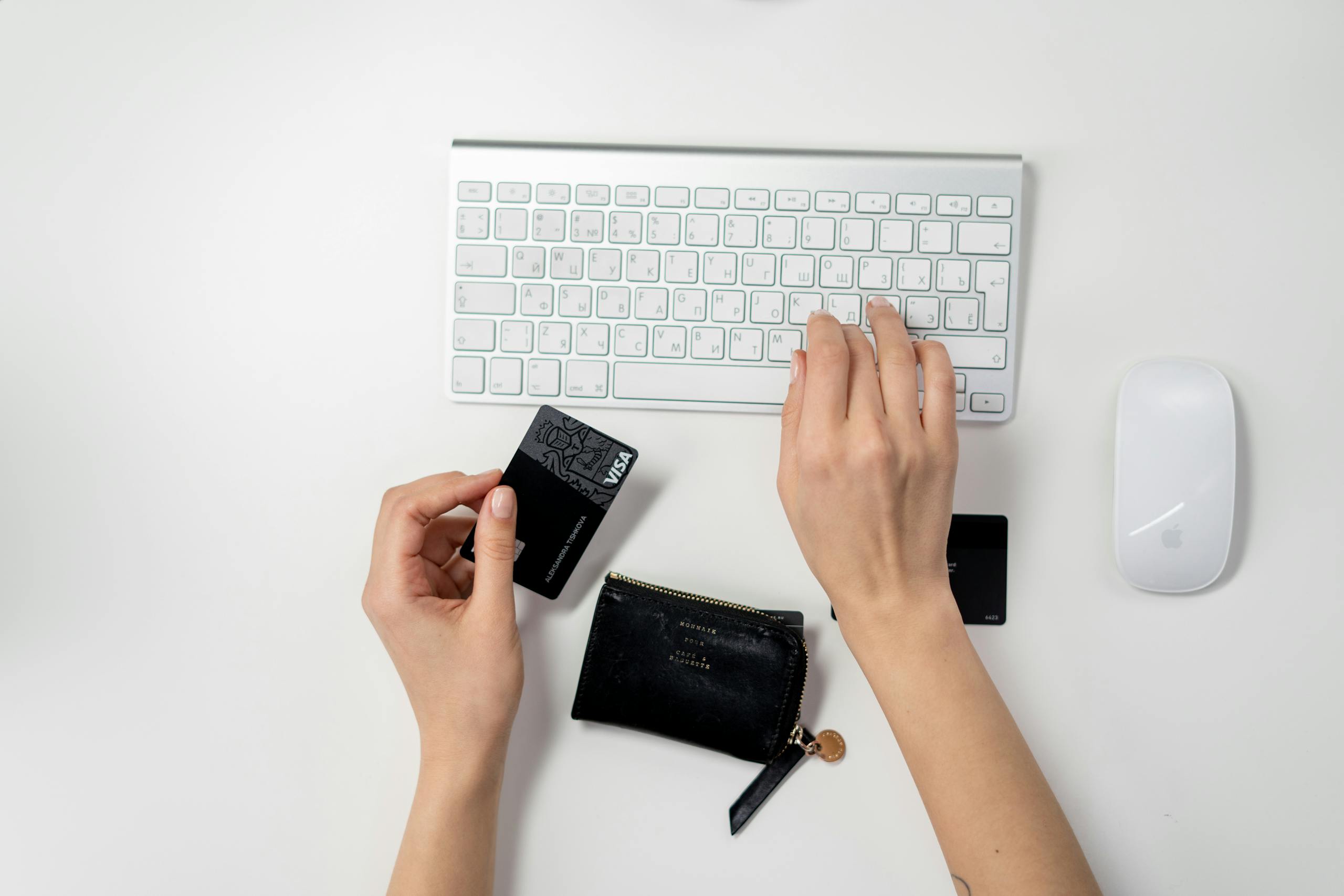 E-commerce setup featuring a keyboard, card, and wallet, ideal for online shopping concepts.
